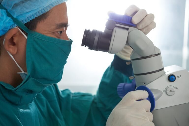 Urologist performing laser stone surgery using an advanced surgical microscope in a modern operating room.
