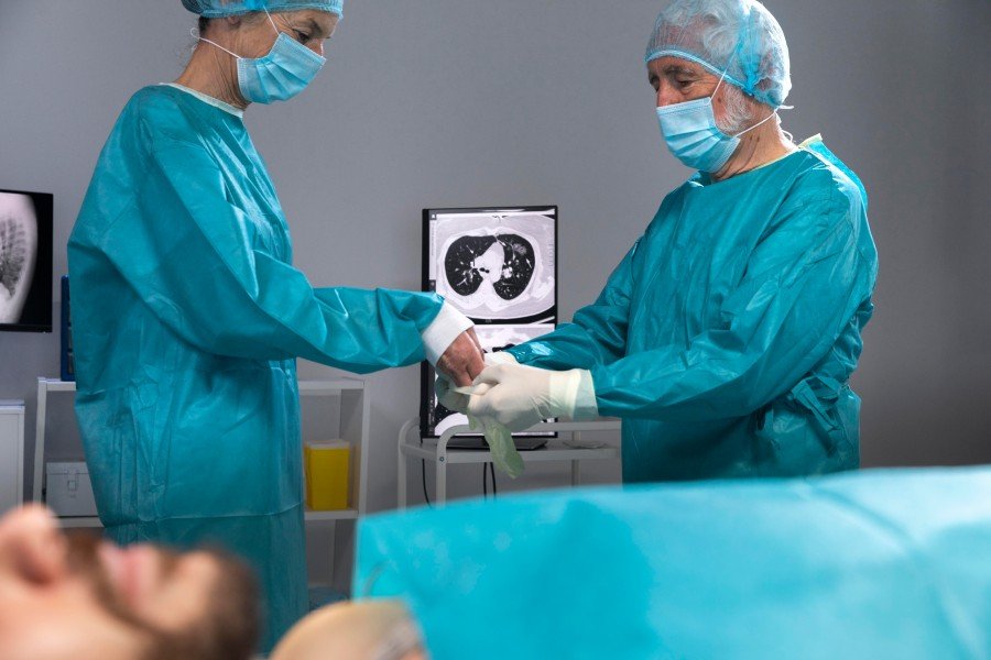 Doctors preparing for a surgical procedure in a hospital operating room