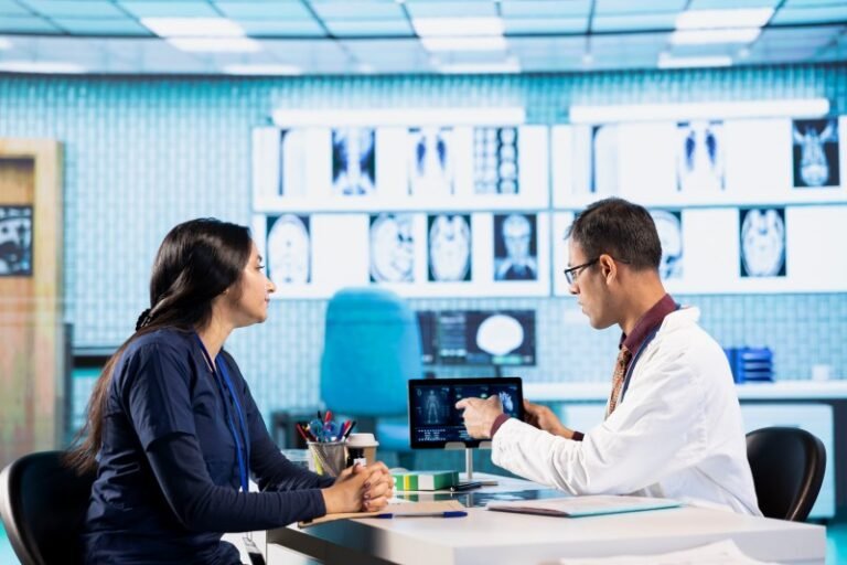 Urologist consulting with a patient while reviewing medical imaging