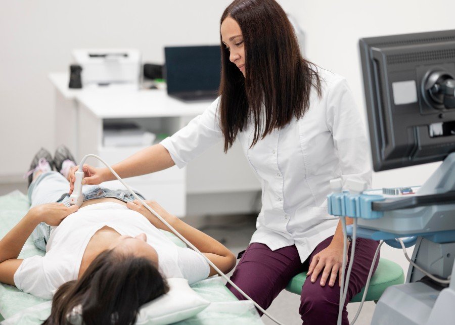 Gynecologist performing an ultrasound examination on a female patient
