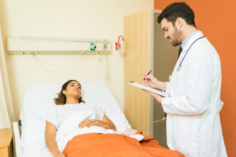 Doctor discussing a female patient’s health condition during a hospital consultation